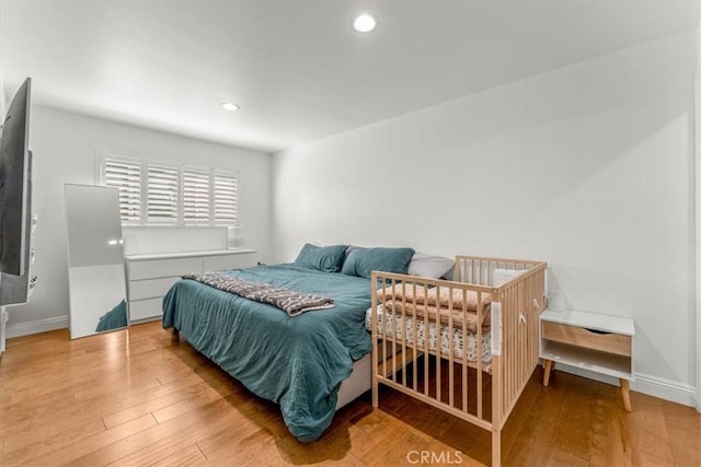 bedroom featuring recessed lighting, baseboards, and wood finished floors