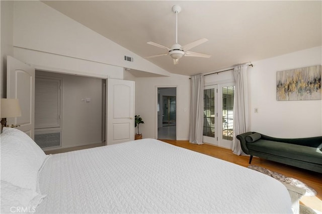bedroom with wood finished floors, visible vents, vaulted ceiling, a ceiling fan, and access to outside