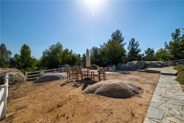 view of yard featuring fence and a patio