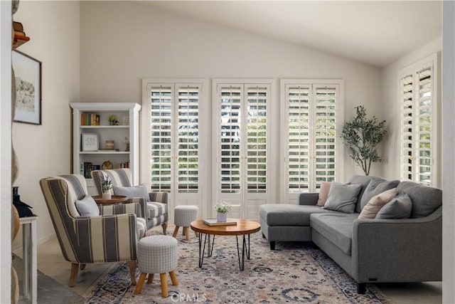 sitting room with lofted ceiling