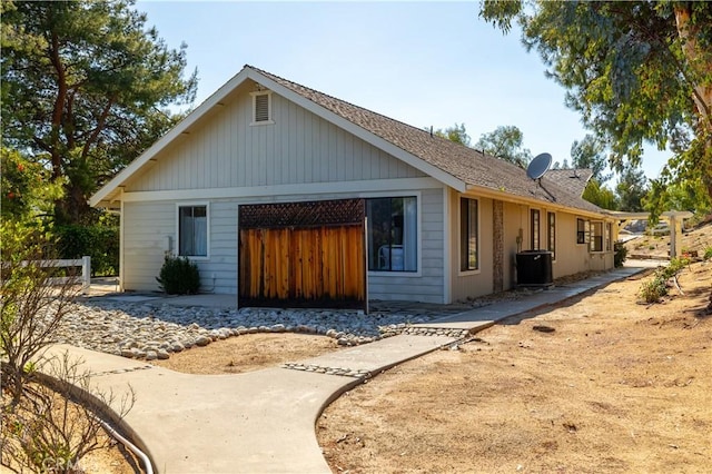 rear view of house featuring cooling unit