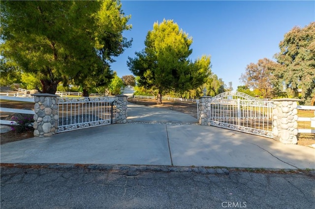 view of gate with fence