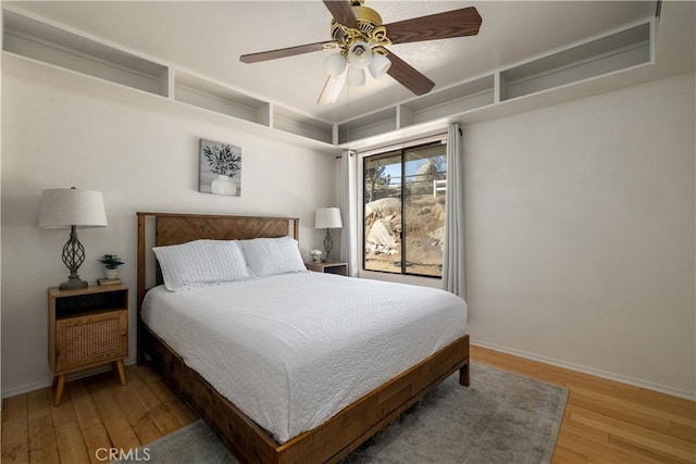 bedroom with light wood-type flooring, baseboards, and ceiling fan