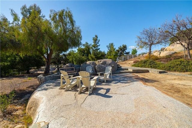 view of home's community featuring a patio and fence