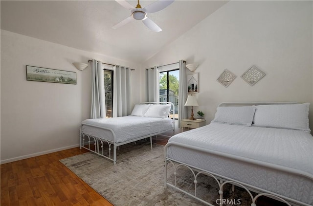 bedroom featuring lofted ceiling, baseboards, a ceiling fan, and wood finished floors