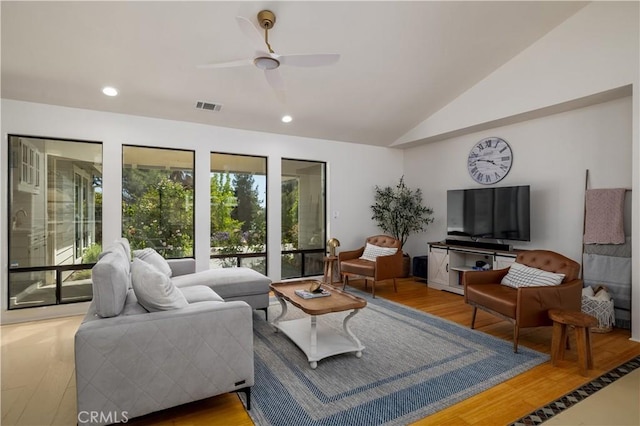 living area with vaulted ceiling, visible vents, wood finished floors, and recessed lighting