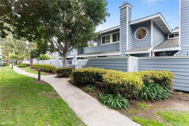 19116 Queensport Ln Unit B, Huntington Beach, CA 92646 - view of side of property with a lawn and a chimney