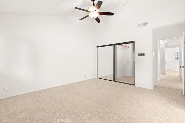 19116 Queensport Ln Unit B, Huntington Beach, CA 92646 - unfurnished bedroom featuring visible vents, a closet, ceiling fan, high vaulted ceiling, and light colored carpet