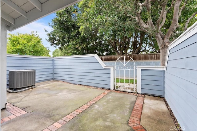 view of patio with cooling unit and a fenced backyard