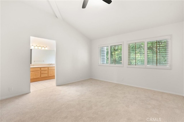 unfurnished room featuring baseboards, lofted ceiling with beams, a ceiling fan, and light colored carpet