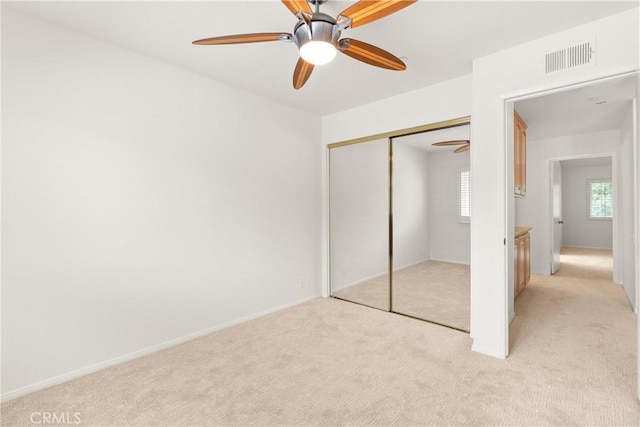 19116 Queensport Ln Unit B, Huntington Beach, CA 92646 - unfurnished bedroom featuring visible vents, a ceiling fan, a closet, and light carpet