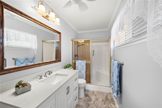 bathroom featuring vanity, a ceiling fan, ornamental molding, and a stall shower