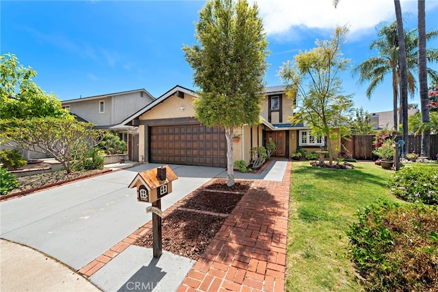 traditional-style home with fence, a front lawn, a garage, stucco siding, and driveway