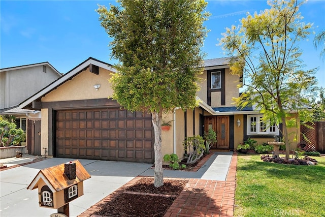 view of front of property featuring a garage, stucco siding, driveway, and a front lawn