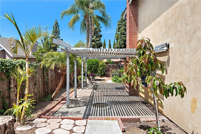 view of patio / terrace with a fenced backyard and a pergola