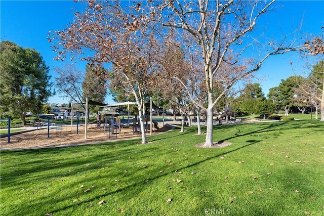 surrounding community featuring a yard and playground community