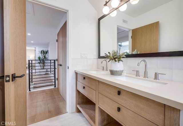 2027 Kornat Dr, Costa Mesa, CA 92626 - full bathroom featuring double vanity, decorative backsplash, and wood finished floors