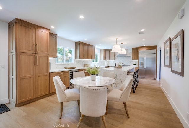 2027 Kornat Dr, Costa Mesa, CA 92626 - dining room featuring beverage cooler, light wood-style floors, recessed lighting, and baseboards