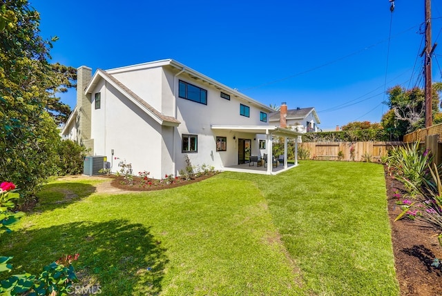 2027 Kornat Dr, Costa Mesa, CA 92626 - back of property featuring a chimney, stucco siding, a patio, and central AC unit