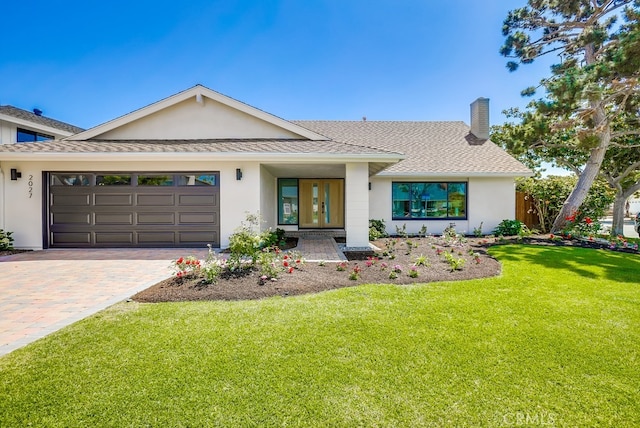 2027 Kornat Dr, Costa Mesa, CA 92626 - view of front of house with a garage, a front yard, stucco siding, a chimney, and decorative driveway