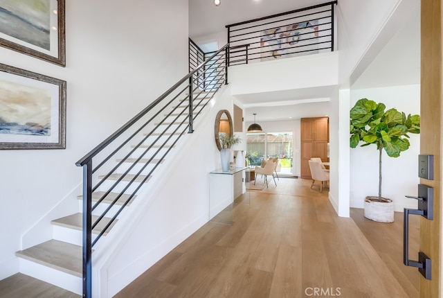 2027 Kornat Dr, Costa Mesa, CA 92626 - stairs featuring wood finished floors, a high ceiling, and baseboards