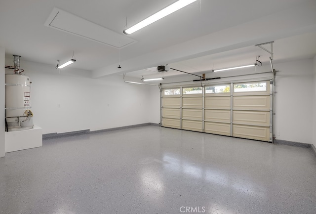 2027 Kornat Dr, Costa Mesa, CA 92626 - garage featuring strapped water heater, a garage door opener, and baseboards