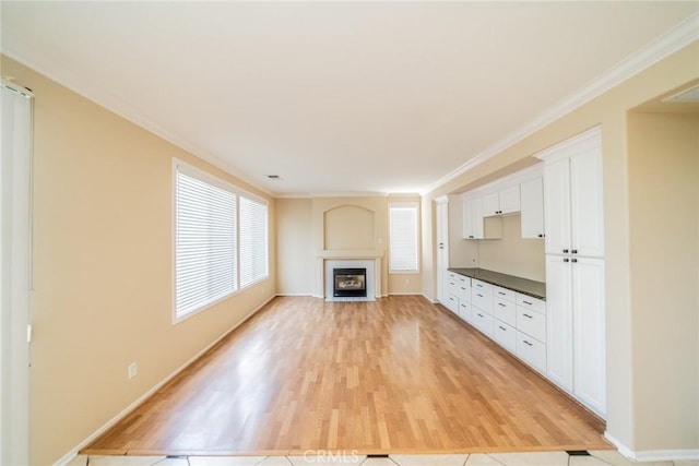 32674 Clearvail Dr, Temecula, CA 92592 - unfurnished living room featuring light wood-style floors, a fireplace with flush hearth, baseboards, and crown molding