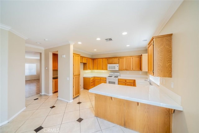 32674 Clearvail Dr, Temecula, CA 92592 - kitchen with white appliances, a peninsula, light countertops, recessed lighting, and crown molding