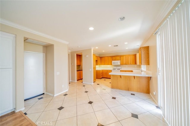 32674 Clearvail Dr, Temecula, CA 92592 - kitchen featuring white microwave, a peninsula, gas range, light countertops, and crown molding