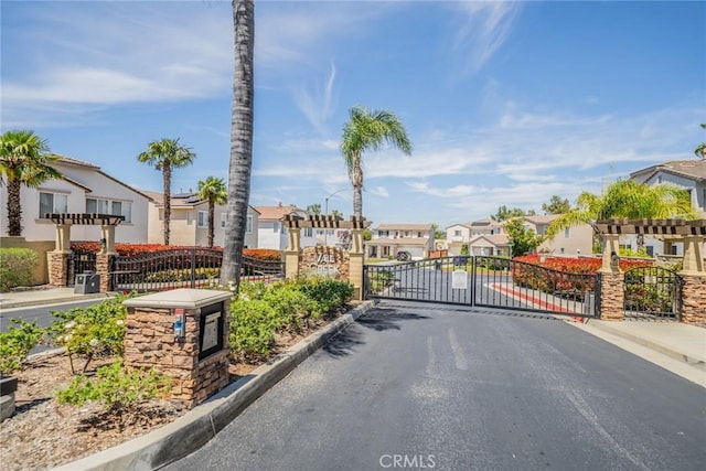 32674 Clearvail Dr, Temecula, CA 92592 - view of asphalt street featuring a residential view, a gate, curbs, a gated entry, and sidewalks