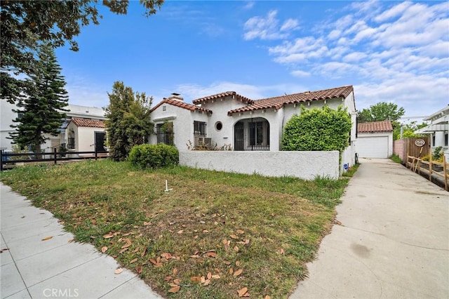 mediterranean / spanish home featuring fence, stucco siding, driveway, and a tile roof