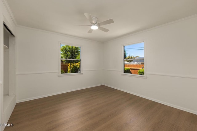 unfurnished room with crown molding, ceiling fan, wood finished floors, and a healthy amount of sunlight