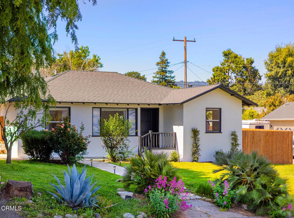 294 Mahoney Ave, Oak View, CA 93022 - view of front of house featuring roof with shingles, fence, stucco siding, and a front lawn