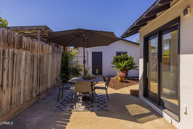 view of patio with fence and outdoor dining area