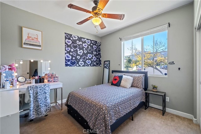 carpeted bedroom with baseboards and a ceiling fan