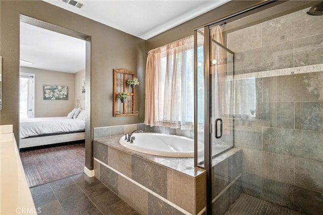 ensuite bathroom with a garden tub, a stall shower, ensuite bath, and visible vents