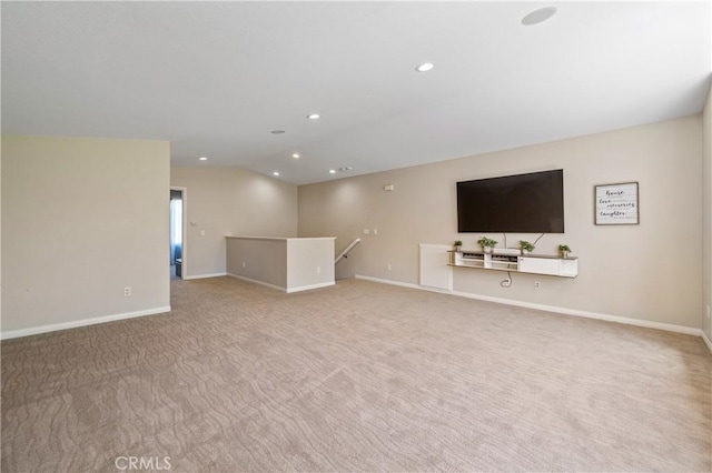 unfurnished living room featuring carpet floors, baseboards, vaulted ceiling, and recessed lighting