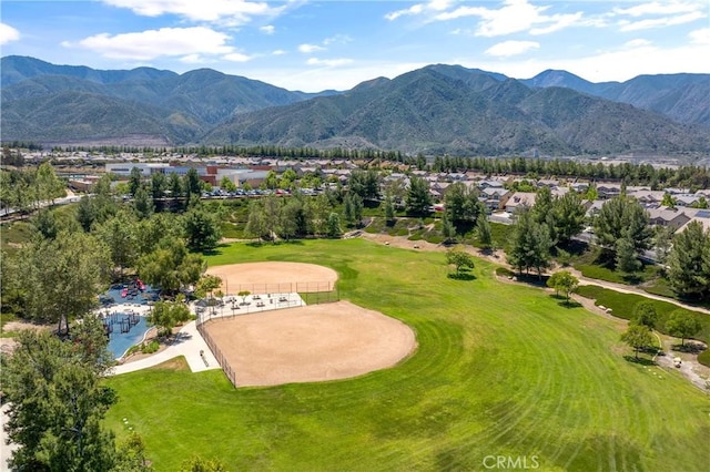 bird's eye view with view of golf course, a mountain view, and a residential view