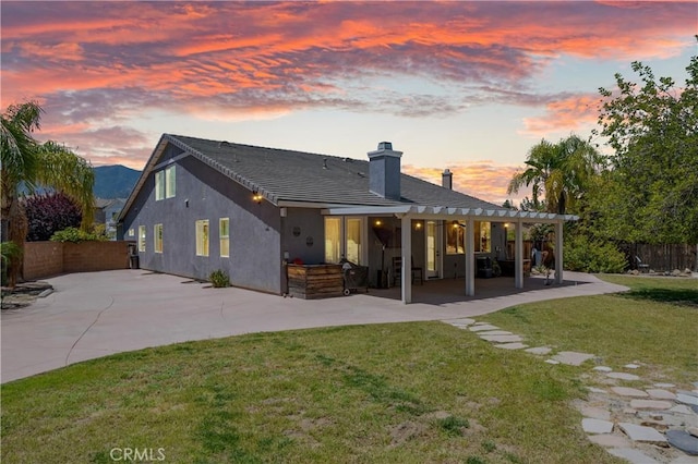 11126 Whitebark Ln, Corona, CA 92883 - back of house with a patio, a chimney, and stucco siding