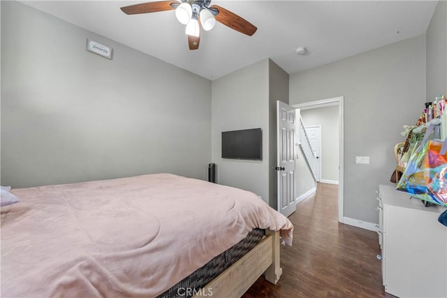 bedroom with baseboards, a ceiling fan, and dark wood finished floors
