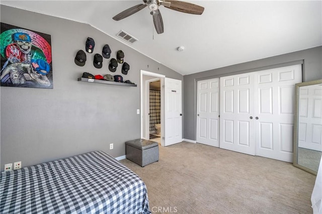 unfurnished bedroom with visible vents, carpet, lofted ceiling, and a closet