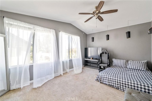 carpeted bedroom featuring a ceiling fan, baseboards, and vaulted ceiling