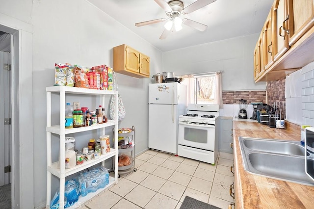 kitchen featuring ceiling fan, a sink, white appliances, light countertops, and decorative backsplash