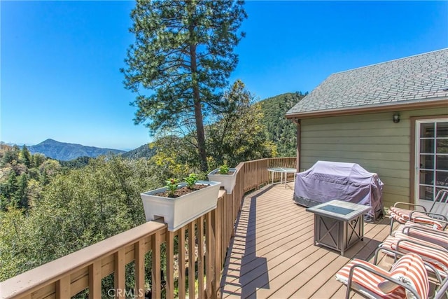 6377 Sugar Pines Cir, Angelus Oaks, CA 92305 - wooden terrace with grilling area, a mountain view, and a view of trees