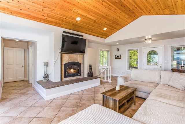 6377 Sugar Pines Cir, Angelus Oaks, CA 92305 - living area with light tile patterned flooring, vaulted ceiling, a tiled fireplace, wood ceiling, and baseboards