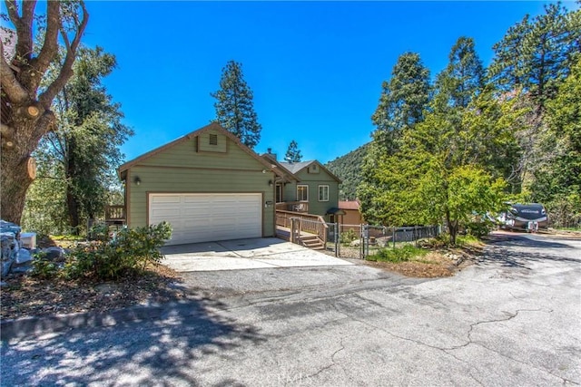 6377 Sugar Pines Cir, Angelus Oaks, CA 92305 - view of front of home with concrete driveway, an attached garage, and fence