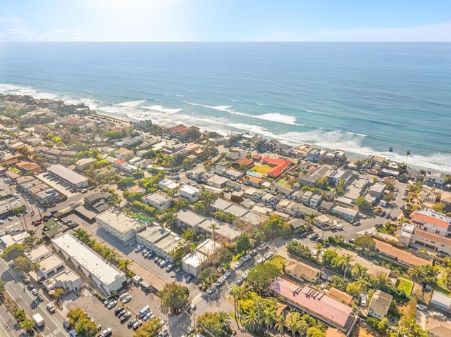 drone / aerial view with a water view and a beach view