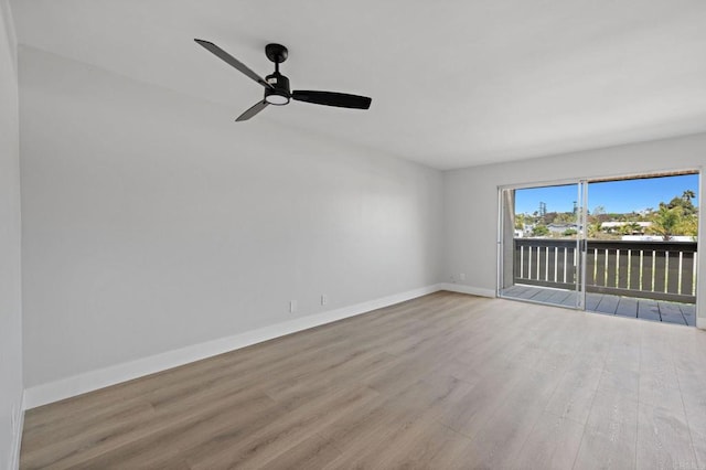 empty room featuring a ceiling fan, baseboards, and wood finished floors