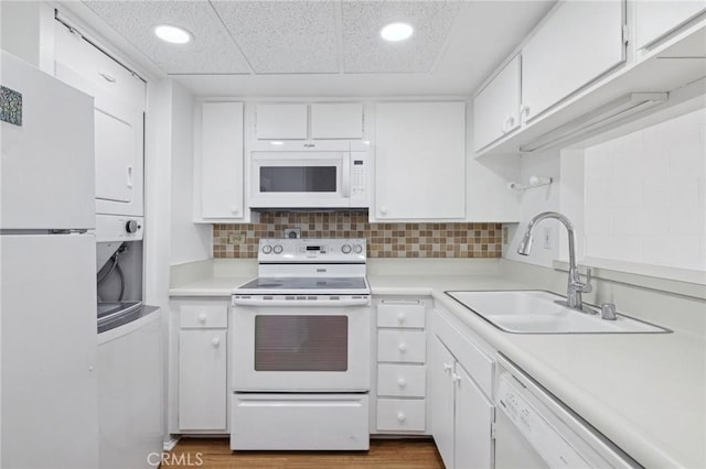 10966 Rochester Ave Unit 5D, Los Angeles, CA 90024 - kitchen with white appliances, white cabinetry, a sink, and light countertops