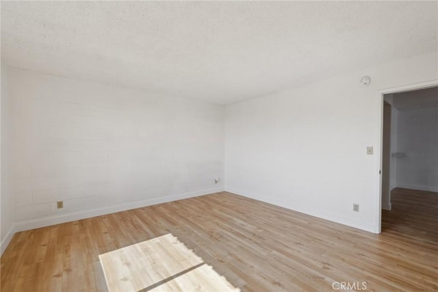 10966 Rochester Ave Unit 5D, Los Angeles, CA 90024 - empty room with baseboards, a textured ceiling, and light wood-style flooring